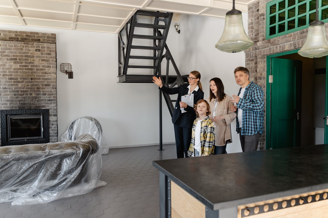 services-06 Family and agent exploring a stylish new home interior together.